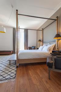 a bedroom with a large bed with a canopy at Maison TANDEM in Cluny +48 photos
