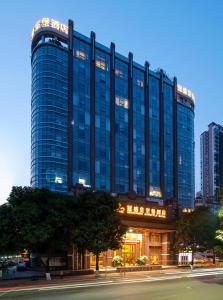 a tall blue building with a street in front of it at Nan Yang Royal Hotel in Guangzhou