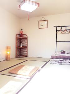 Zimmer mit einem Bett und einem Regal in der Unterkunft Guesthouse Kyoto Kaikonoyashiro in Kyoto