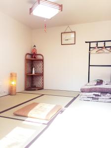 a room with a bed and a shelf at Guesthouse Kyoto Kaikonoyashiro in Kyoto