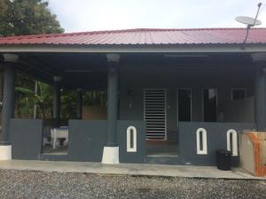 a house with a roof with the number on it at Roomstay Zulmi in Arau