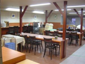 a restaurant with tables and chairs in a room at Takasaki Ekimae Plaza Hotel in Takasaki