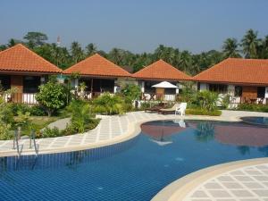 a swimming pool in front of a resort at Sailom Resort Bangsaphan in Bang Saphan