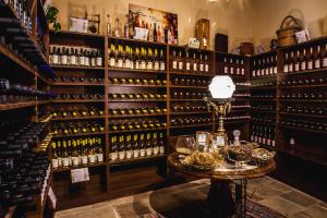 
a wine cellar filled with bottles and wine glasses at Stou Kir Yianni in Omodos
