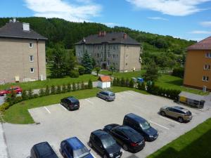 a parking lot with several cars parked in it at Apartmány Liptov in Liptovský Mikuláš