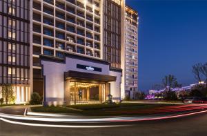 a rendering of the front of a hotel at night at Novotel Hefei Sunac in Hefei