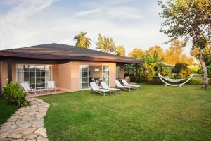 a house with a hammock in the yard at IC Hotels Santai Family Resort - Kids Concept in Belek