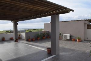 a patio with potted plants on a house at Ocean Mist in Flic-en-Flac