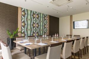 a conference room with a long table and chairs at Three Corners Lifestyle Hotel in Budapest
