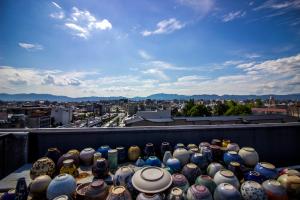 a pile of vases sitting on top of a balcony at Santiago Guesthouse Kyoto in Kyoto