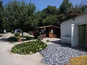 a garden in front of a building with a house at Camping du Creulet in Crouay +33 photos