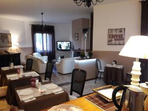 a living room with tables and chairs and a living room at Brunelli Residence in Mazara del Vallo