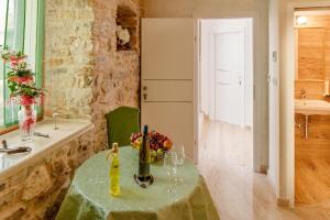 a kitchen with a table with a green table cloth at Stone house luxury rooms in Split +46 photos