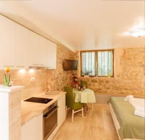 a kitchen with a sink and a table in a room at Stone house luxury rooms in Split