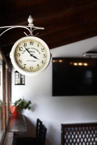 a clock hanging from the ceiling of a room at Elizabeth House in Skopje