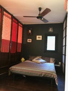 a bedroom with a bed and a ceiling fan at Village Naturiste Le Cap d'Agde villa Port Nature in Cap d'Agde