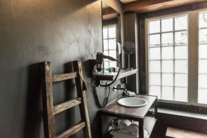 a bathroom with a sink and a mirror at Van Rossum Stadshotel Woerden in Woerden