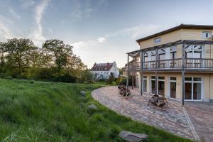 a house with two horses in front of it at Hotel Gutshaus Parin - Bio- und Gesundheitshotel in Parin