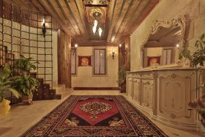 a hallway of a building with a rug on the floor at Grand Cappadocia Hotel in Goreme