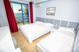 Postel nebo postele na pokoji v ubytování Hotel Nimfa
