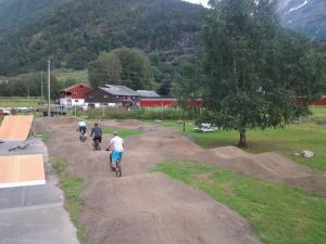 a group of people riding bikes down a dirt road at Folven Adventure Camp in Hjelle