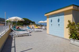 a group of lounge chairs and umbrellas on a building at Hotel Crawford in Sant'Agnello
