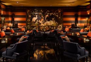 a lobby with couches and tables and a painting at Blakes Hotel in London