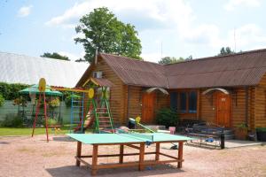a house with a ping pong table in front of it at Galicky Dvir Hotel in Svityazʼ