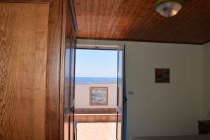 a room with a door with a view of the ocean at Hotel La Certosa in Massa Lubrense