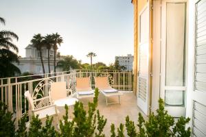 a balcony with three chairs and a table at Hotel Crawford in Sant'Agnello