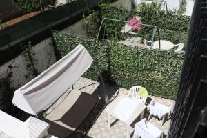 a group of chairs and umbrellas on a patio at Le Tre Rose Bed & Breakfast in Casamassima