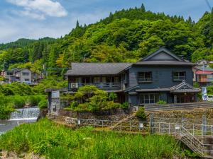 a house on the side of a mountain at Takaosou in Yufuin