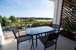 a table and chairs on a balcony with a view at Kollari Apartments in Ulcinj