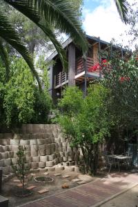 a house with a staircase in front of it at De Vagebond Hotel-Pension in Windhoek