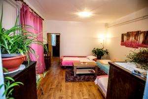 a room with two beds and a table in it at Apartman Oaza in Trebinje