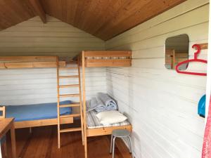 a bunk bed in a cabin with a ladder at Keldunes in Garður