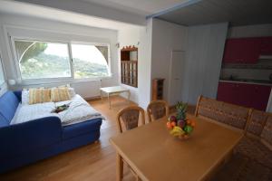 a living room with a blue couch and a table at Lloret Apartments in Lloret de Mar