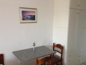 a dining room with a table and a picture on the wall at Gikas Apartments Triple Studio Sea View B7 in Marmari +45 photos