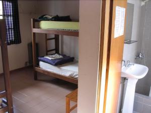 a room with bunk beds and a sink in a room at Puma Hostel in San Martín de los Andes