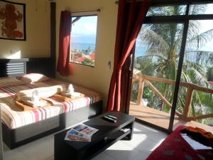 a bedroom with two beds and a view of the ocean at Moonstone Studio in Haad Rin