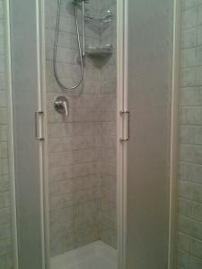 a shower with a glass door in a bathroom at Hotel Brufa in Monteleone di Spoleto