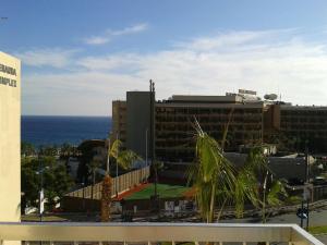 a view of a building with the ocean in the background at Limassol Seaside Apartment in Limassol