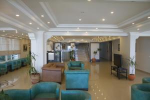 a lobby with couches and chairs and a television at Amphora Hotel in Ayvalık +86 photos
