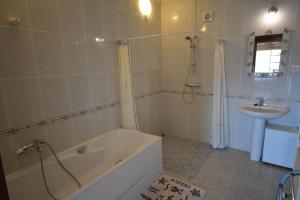 a bathroom with a tub and a sink at Lloret Apartments in Lloret de Mar +33 photos