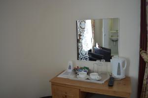 a bathroom vanity with a mirror and a sink at Globe Hotel in Colchester