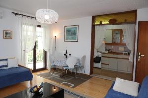 a living room with a table and a kitchen at Apartments Knezović in Rovinj