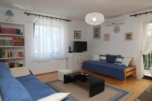 a living room with a bed and a couch at Apartments Knezović in Rovinj