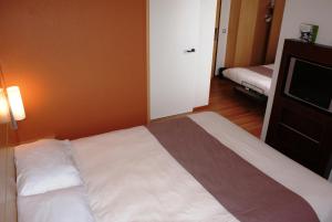 Rúm í herbergi á ibis Hotel Brussels Expo Atomium