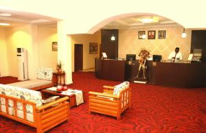 a hotel lobby with couches and a reception desk at Sweet Spirit Hotel and Suites Danag - Port Harcourt in Port Harcourt