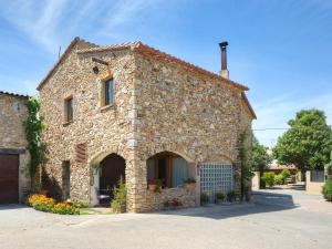 a large stone building with a gate in front of it at Can Barrull-Costa Brava-Emporda in San Felíu de Boada